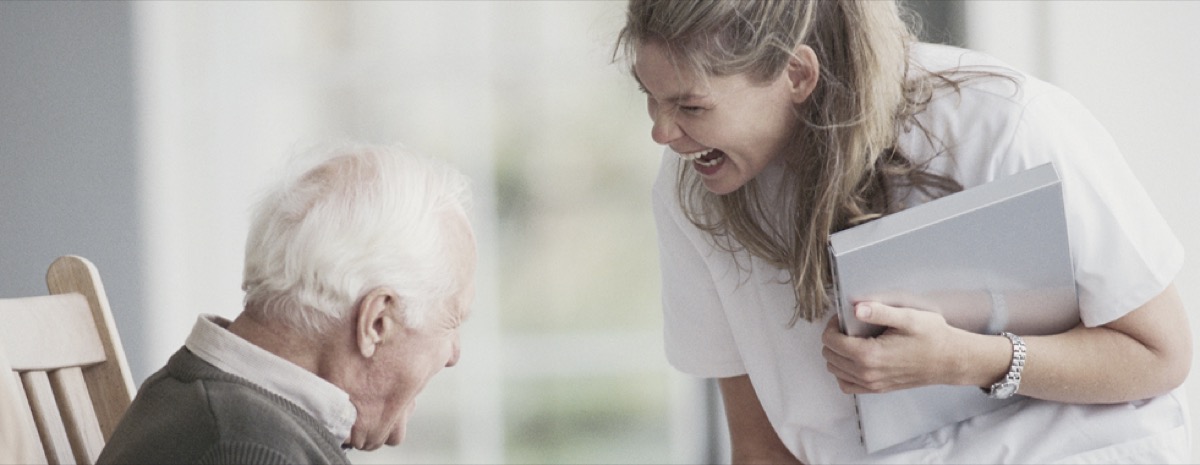 A caregiver with a client outside a home